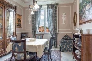 una sala da pranzo con tavolo, sedie e una finestra di Casa Alessandro a Firenze