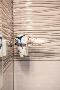 a white and blue cup hanging on a wall at Haus Kärnten in Döbriach +186 photos