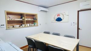 a conference room with a wooden table and chairs at KeiCo in Narusawa +13 photos