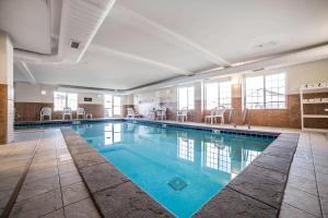 a large swimming pool with blue water in a building at Comfort Inn & Suites Rock Springs-Green River in Rock Springs