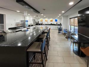 a restaurant with a bar with chairs and tables at Comfort Inn Dallas Park Central in Dallas