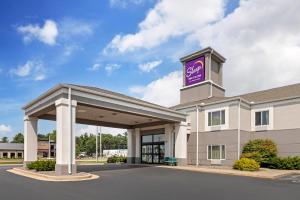 a hotel with a sign on top of a building at Sleep Inn & Suites in Wisconsin Rapids