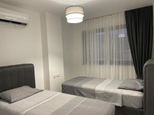 a bedroom with two beds and a window at Penthouse Blueberry in Kérynia
