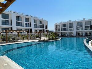 a large swimming pool in front of a building at Penthouse Blueberry in Kérynia +9 photos