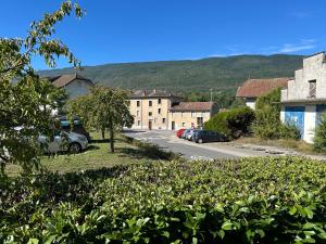 a small town with cars parked in a parking lot at Lappart in Seyssel