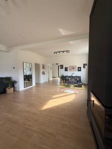 a large living room with a hard wood floor at Cabana NORD - Ciubăr & Saună - Cazare Transalpina, Cazare Luncile Prigoanei, Oașa, Șureanu in Tău Bistra