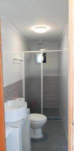 a bathroom with a toilet and a sink at Casa Benito Resort 