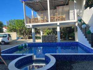 a house with a swimming pool with a balcony at Casa Benito Resort in Sauay
