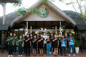 a group of people standing in front of a building at Ilocos Urban Wave Resort Hotel in Laoag