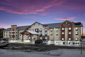 a large hotel in a parking lot with snow at MainStay Suites Gaylord in Gaylord +32 photos