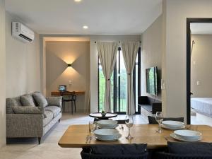 a living room with a table and a couch at Nicer Sector M in Santa Cruz Huatulco