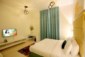 a hotel room with a bed and a television at DREAM PALACE HOTEl in Ras al Khaimah
