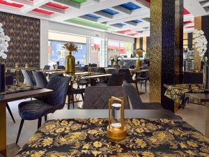a dining room with tables and chairs in a restaurant at HH Riz Resort - Adults Only in Maspalomas