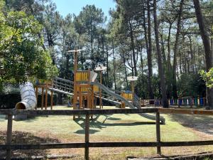 a playground with a slide in a park at La Perle des Pins LACANAU OCEAN in Lacanau