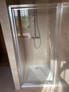a shower with a glass enclosure in a bathroom at Villa Corleone in Nizza Monferrato +13 photos