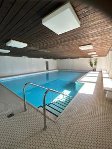 a large swimming pool in a building at Allgäu Loft Obermaiselstein mit Privatsauna in Obermaiselstein
