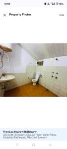 a bathroom with a toilet and a sink at Aagman Homestay & Rooftop Restaurant in Mussoorie