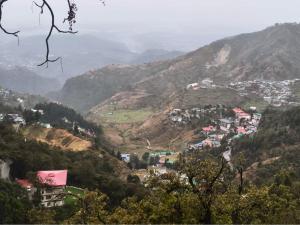 a view of a town on a mountain at Aagman Homestay & Rooftop Restaurant in Mussoorie