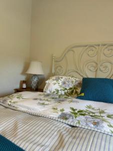 un letto con un copriletto bianco con fiori sopra di The Hollow a Laois Altre 7 foto