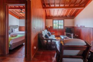 a room with a bedroom with a bed and a desk at Refúgio do Sol - Azorean Butler in Mosteiros +71 photos