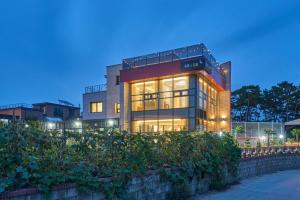 a large building with many windows at night at Daebudo DuMong DalGeum Pool Villa in Ansan