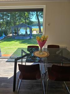 a glass table with a vase of fruit on it at Mi-Chałki Kalwa Lake House in Michalki