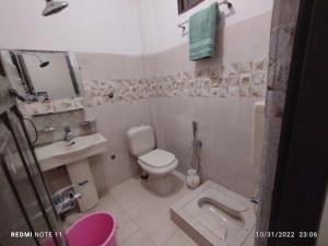a small bathroom with a toilet and a sink at RC Hotel in Dargai