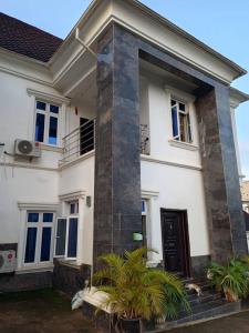 a white house with a dog laying in front of it at Tastefully furnished 4bedrooms Guzape with pool in Abuja