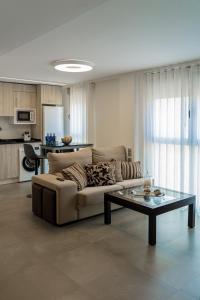 a living room with a couch and a table at Piso-loft AOVE pleno centro in Jaén
