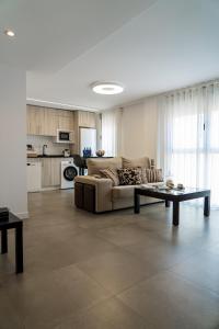 a living room with a couch and a table at Piso-loft AOVE pleno centro in Jaén