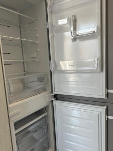 an empty refrigerator with its door open with its door at Елегія парк in Odesa +9 photos