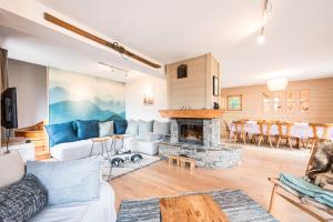 a living room with a couch and a fireplace at Chalet Marmotte in Saint-Martin-de-Belleville