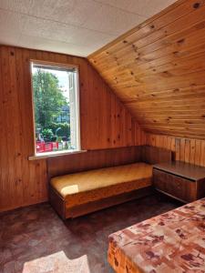 a room with a bed and a window at Basanavičiaus kambarelis in Palanga