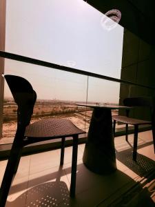 a table and a chair in front of a window at Spacious Luxury Lagoon View 2Bhk in Dubai +7 photos