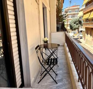a small table on the balcony of a building at Mυρσίνη in Komotini