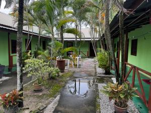 a courtyard of a house with palm trees at Summer Lodge in Pantai Cenang