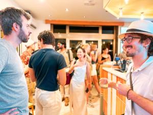 a group of people standing around a bar at Ostello Bello Bologna in Bologna