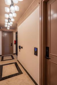 a corridor with a door and a hallway with a hallway at Micasa Suites in New Delhi