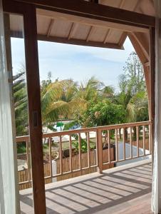 a view of the beach from the porch of a house at Villa Lumbung Uluwatu 2 in Uluwatu +20 photos