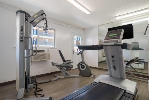 a fitness room with a treadmill and a gym at Suburban Studios Biloxi North Area in Biloxi