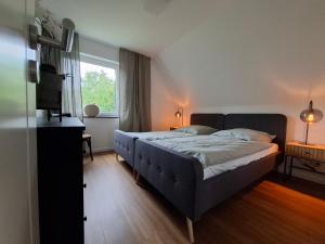 a bedroom with a large bed and a window at Bright 3-room apartment - space for family & friends in Tecklenburg
