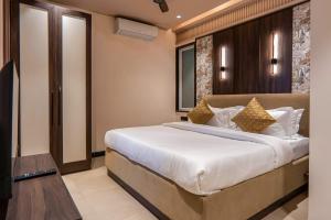 a bedroom with a large bed in a room at Micasa Suites in New Delhi