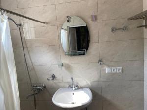 a bathroom with a sink and a mirror on the wall at BEATRIS in Ureki