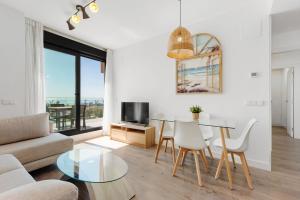 una sala de estar con una mesa y un sofá en Adhara 053, en Torre del Mar