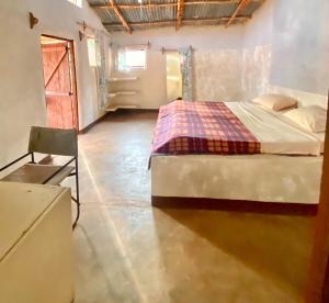 a bedroom with a bed in a room at Weavers Nest, Nyika Eco Cottages in Mtito Andei