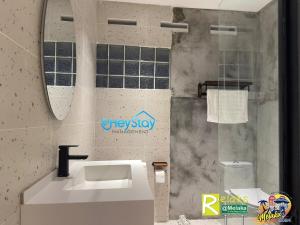 a bathroom with a sink and a mirror at MalayaVilla 5R3B16Pax PrivatePool Karaok PlayGround in Gua Sai +31 photos