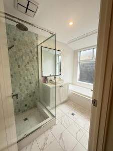 a bathroom with a glass shower and a sink at 12 Beautiful Brabham Big Backyard 4BR Parking in Perth +39 photos