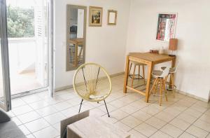 a living room with a table and a chair at Olive Hideout in Gajac