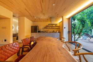 a large wooden table in a room with a kitchen at farm and bed SETODA in Onomichi