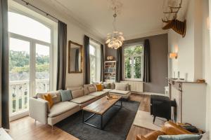 a living room with a couch and a table at Villa Louise in Durbuy